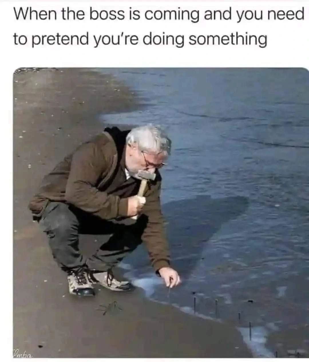 man nailing things into the sea to look busy