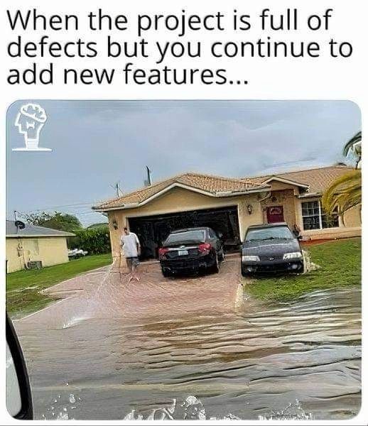 man spraying a driveway during a flood